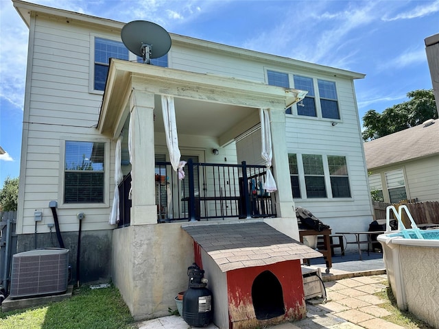 rear view of house with central AC unit