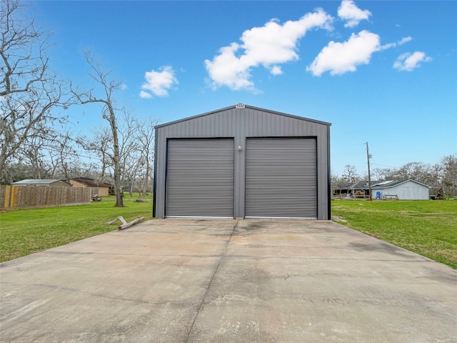 detached garage featuring fence