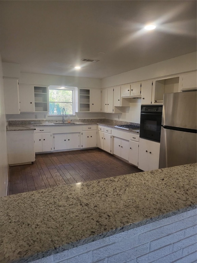 kitchen featuring white cabinetry, appliances with stainless steel finishes, sink, and dark hardwood / wood-style flooring