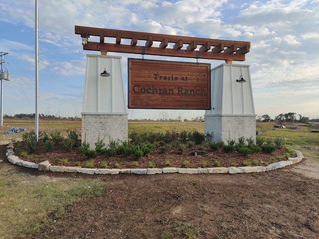 community sign featuring a rural view