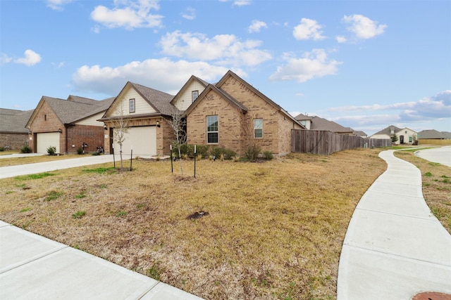 view of front of property featuring a garage and a front lawn