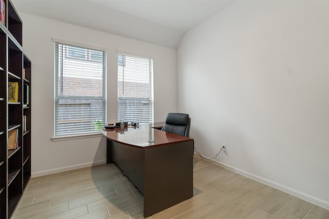 home office with lofted ceiling and light wood-type flooring