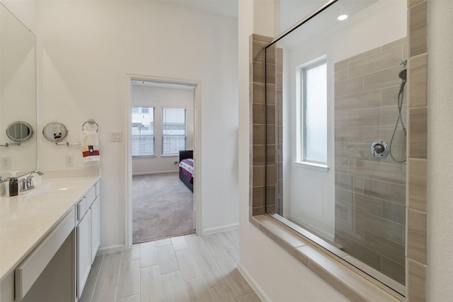 bathroom with vanity, plenty of natural light, and a tile shower