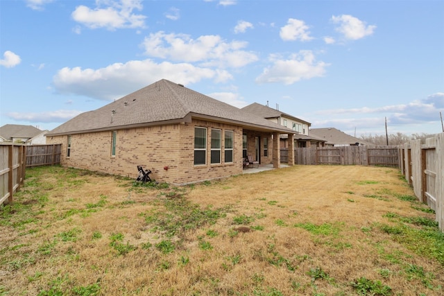 back of property featuring a yard