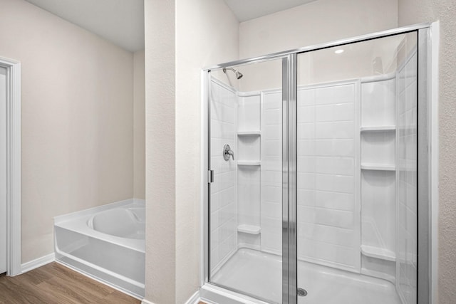 bathroom with shower with separate bathtub and hardwood / wood-style floors