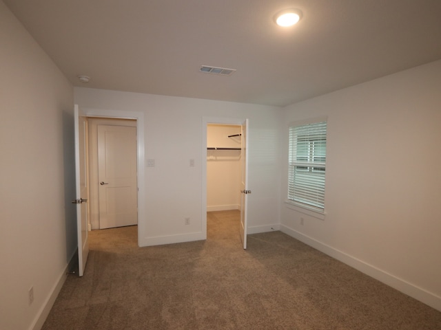 8515 Pier Cove Dr, Cypress, TX 77433 - unfurnished bedroom featuring carpet and a walk in closet