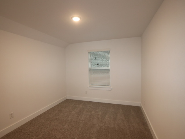8515 Pier Cove Dr, Cypress, TX 77433 - empty room with dark colored carpet and baseboards