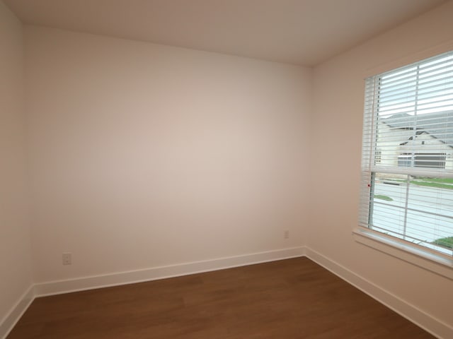 8515 Pier Cove Dr, Cypress, TX 77433 - spare room with dark wood-type flooring and baseboards