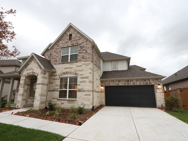 8515 Pier Cove Dr, Cypress, TX 77433 - view of front of home with roof with shingles, stone siding, driveway, and an attached garage
