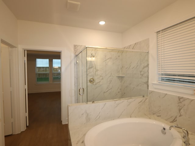 8515 Pier Cove Dr, Cypress, TX 77433 - bathroom featuring a garden tub, a marble finish shower, wood finished floors, and recessed lighting
