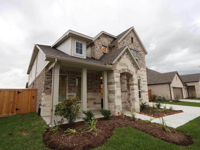 8515 Pier Cove Dr, Cypress, TX 77433 - view of front of property featuring stone siding, a shingled roof, brick siding, an attached garage, and a gate