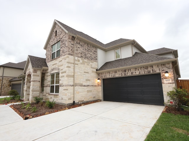 8515 Pier Cove Dr, Cypress, TX 77433 - view of front of property featuring stone siding, a shingled roof, a garage, driveway, and stucco siding