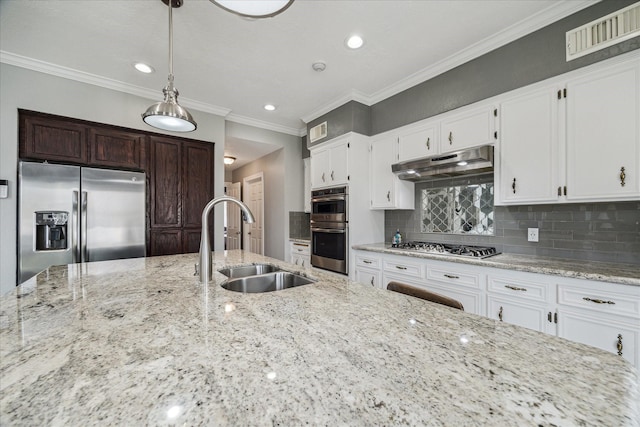 kitchen with sink, white cabinetry, pendant lighting, stainless steel appliances, and decorative backsplash