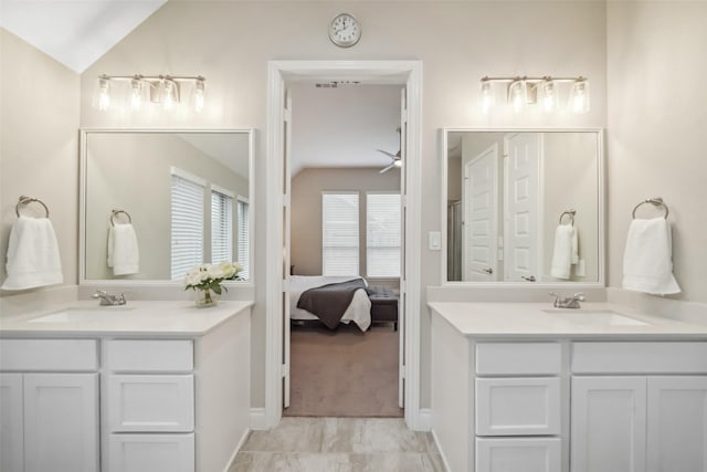 bathroom with vaulted ceiling and vanity