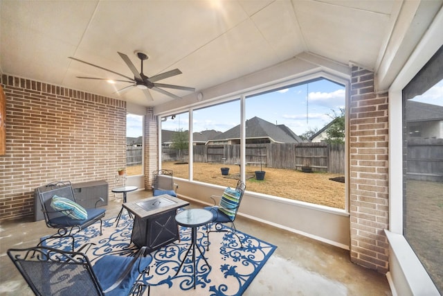 sunroom featuring vaulted ceiling and ceiling fan