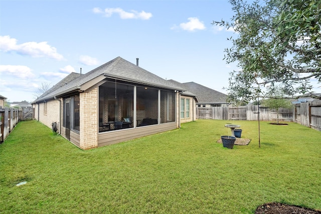 back of house with a lawn and a sunroom