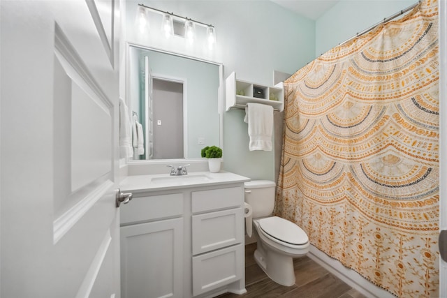 bathroom featuring a shower with curtain, vanity, wood-type flooring, and toilet