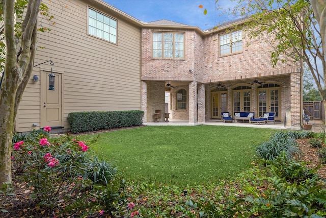 rear view of house featuring ceiling fan, an outdoor hangout area, a patio area, and a lawn