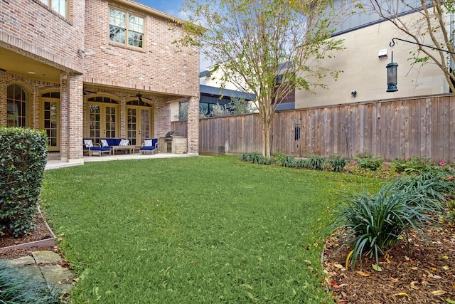 view of yard featuring a patio and ceiling fan