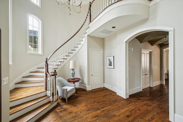 interior space featuring hardwood / wood-style floors, a healthy amount of sunlight, and a high ceiling