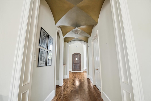 corridor featuring dark hardwood / wood-style flooring and lofted ceiling