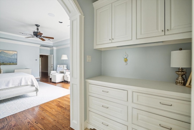 bedroom featuring crown molding and wood-type flooring