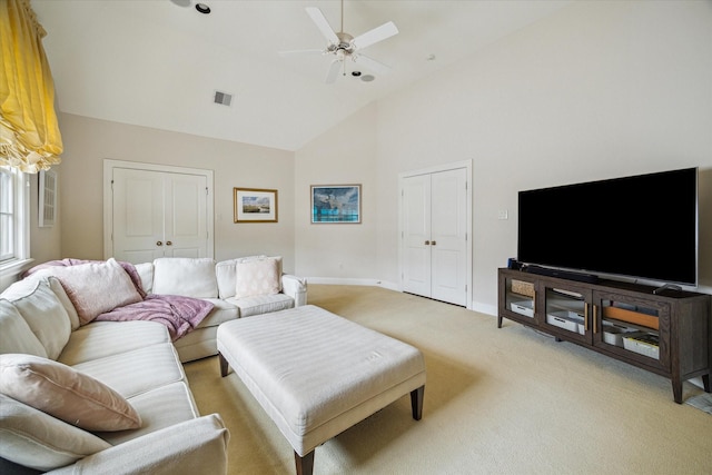 carpeted living room with high vaulted ceiling and ceiling fan