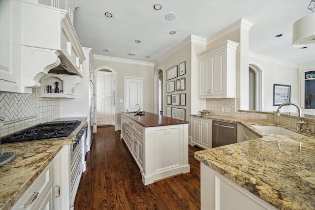 kitchen featuring sink, crown molding, dark stone countertops, white cabinets, and dark hardwood / wood-style flooring