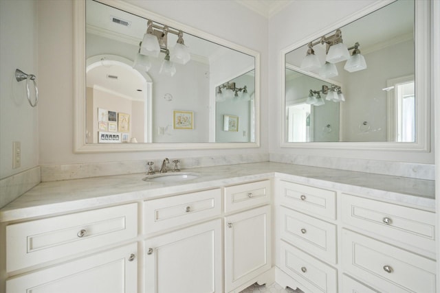 bathroom featuring ornamental molding and vanity