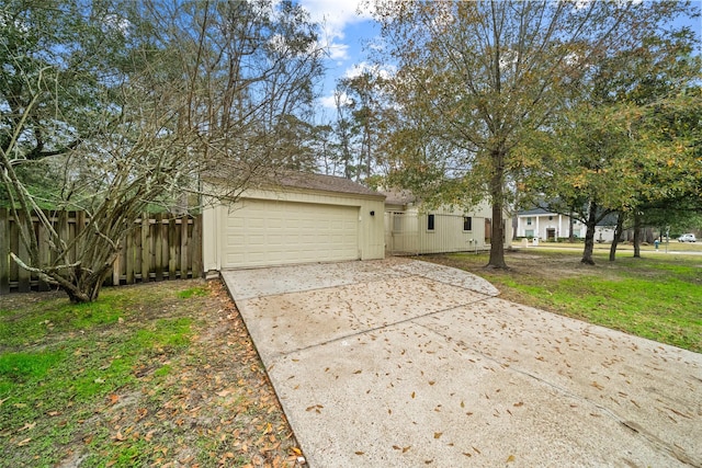 exterior space with a garage and a lawn