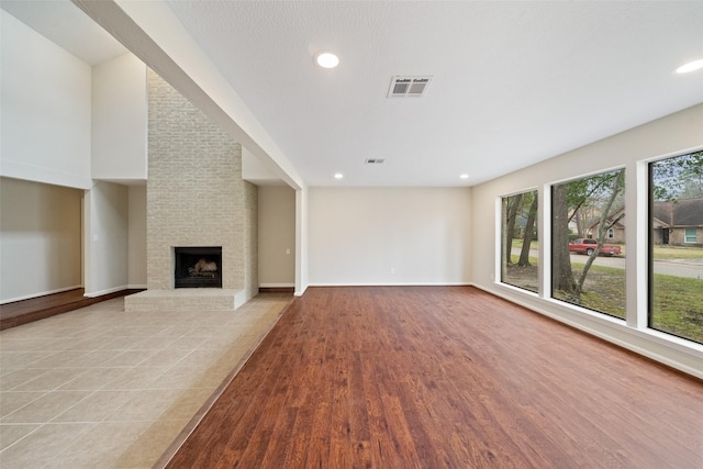 unfurnished living room featuring a fireplace and light wood-type flooring