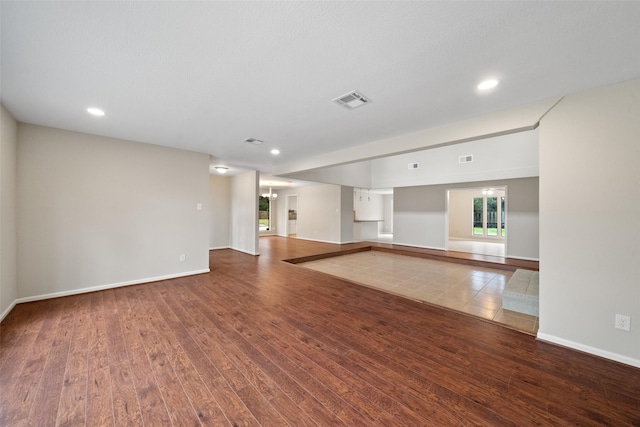 unfurnished living room featuring hardwood / wood-style flooring