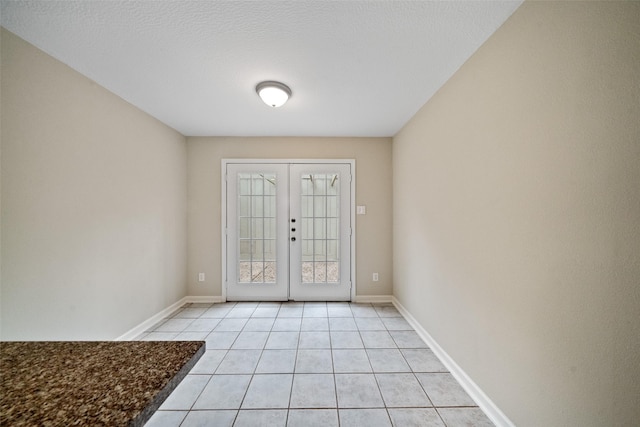 doorway to outside featuring light tile patterned floors and french doors