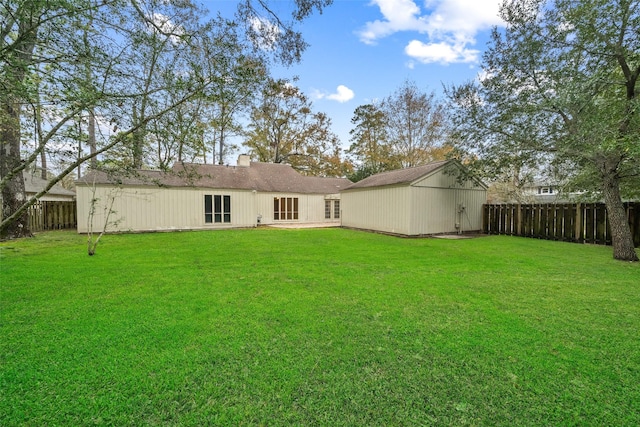 rear view of house with a yard