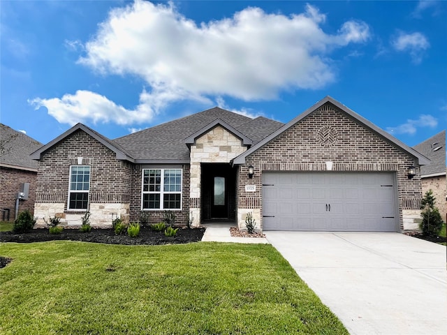 view of front facade with a garage, driveway, brick siding, and a front lawn