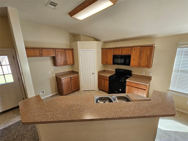 kitchen with vaulted ceiling, sink, a wealth of natural light, and black appliances