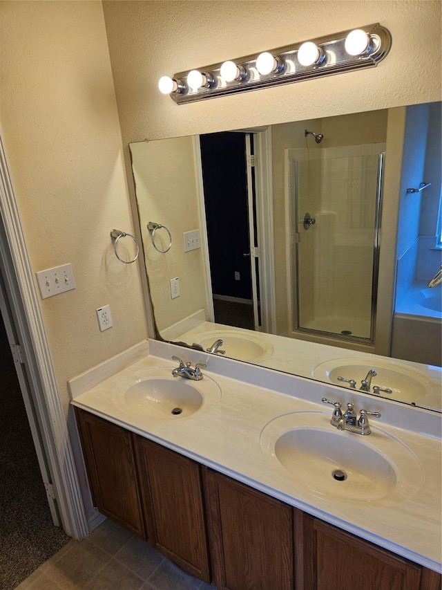 bathroom with vanity, tile patterned floors, and walk in shower