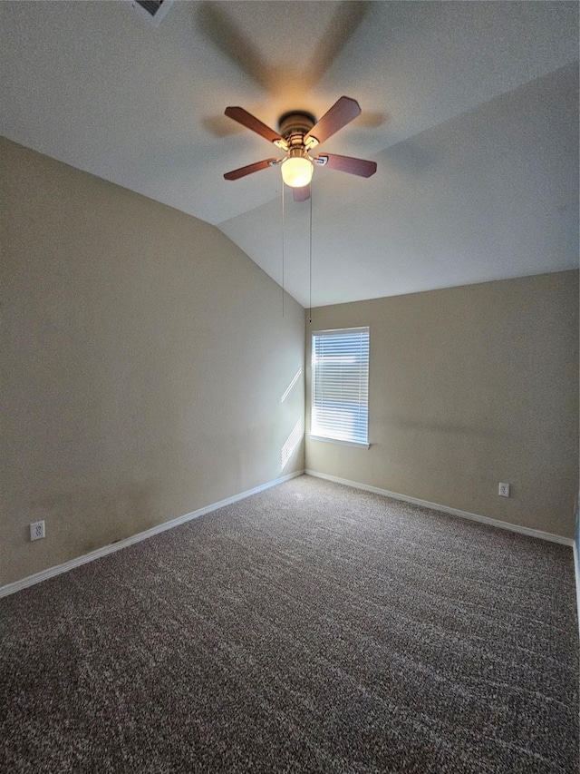 empty room with lofted ceiling, carpet floors, and ceiling fan