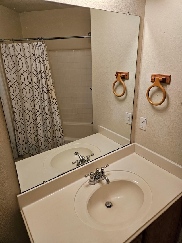 bathroom featuring vanity and shower / bath combo with shower curtain