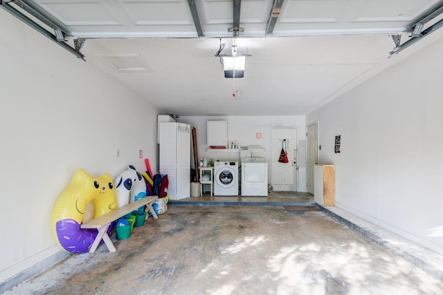 garage with a garage door opener and washing machine and dryer