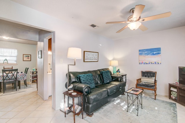 tiled living room with ceiling fan