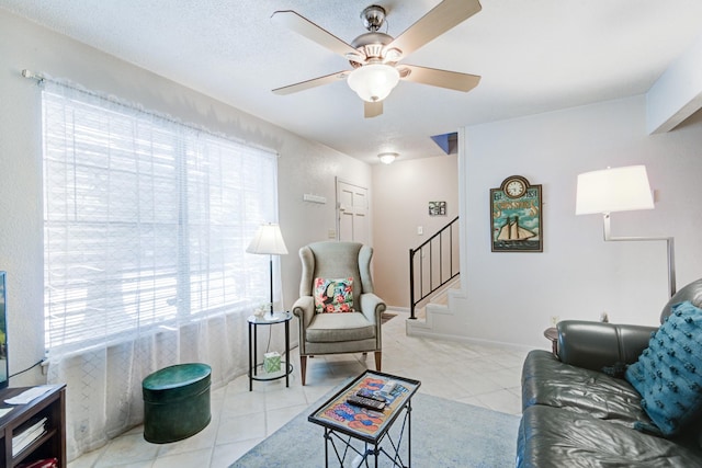 living room with light tile patterned floors and ceiling fan