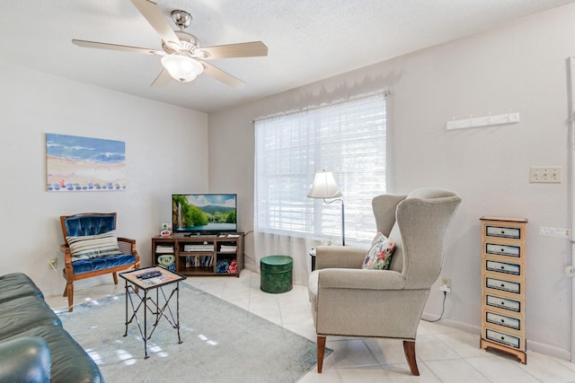 living room with light tile patterned floors, a textured ceiling, and ceiling fan