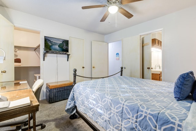 bedroom with ceiling fan, connected bathroom, and carpet