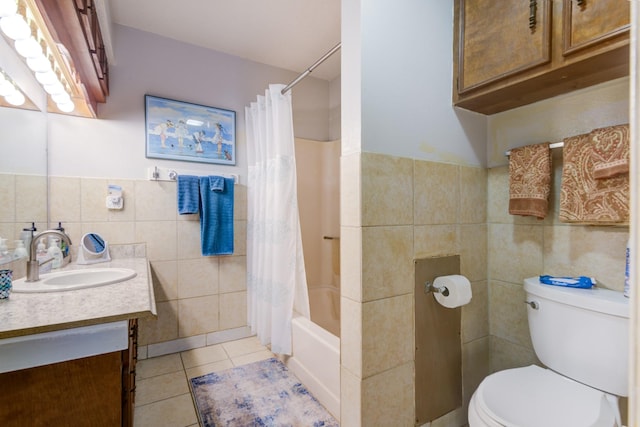 full bathroom with shower / tub combo with curtain, tile patterned floors, toilet, tile walls, and vanity