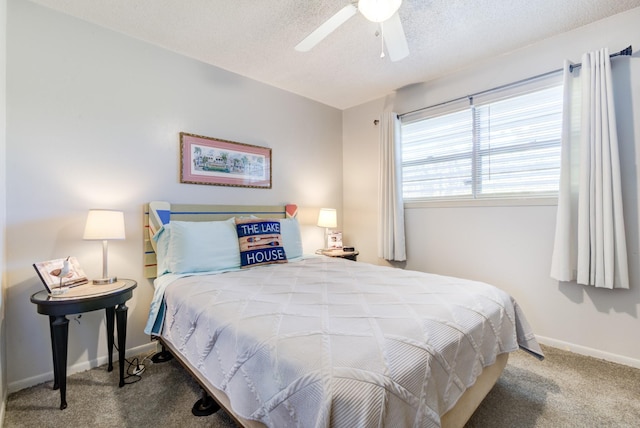 carpeted bedroom with ceiling fan and a textured ceiling