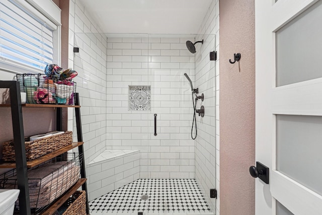 bathroom featuring a shower with door