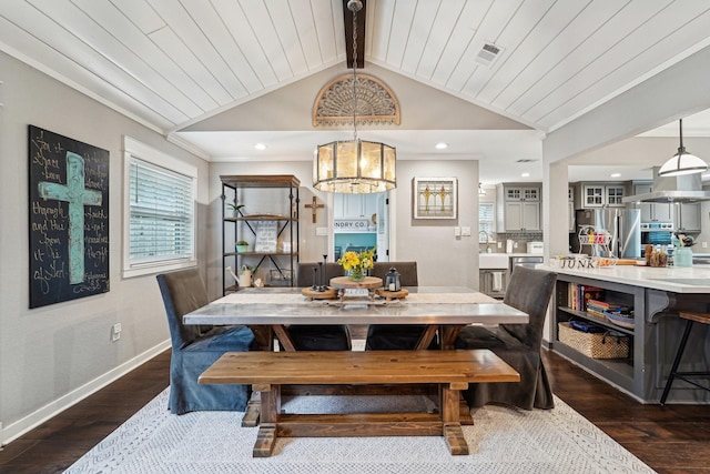 dining area featuring lofted ceiling with beams, crown molding, dark hardwood / wood-style floors, and wood ceiling