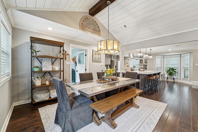 dining space featuring ornamental molding, dark hardwood / wood-style floors, a chandelier, and vaulted ceiling with beams