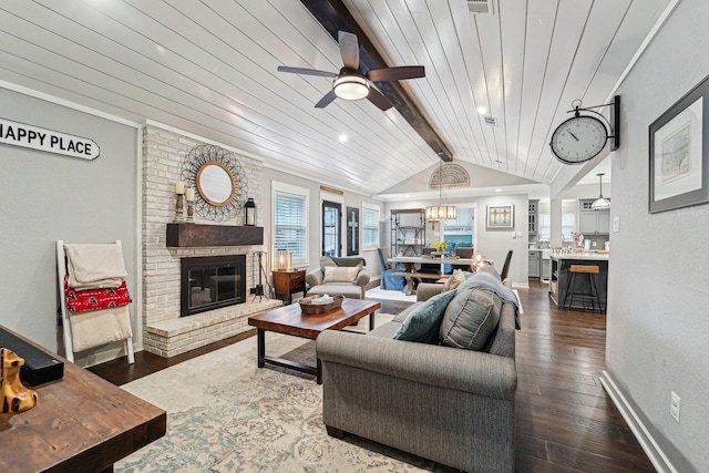 living room with ceiling fan, dark hardwood / wood-style floors, a fireplace, lofted ceiling with beams, and wooden ceiling